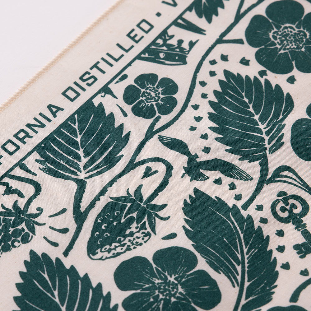 Corner detail of the white bandana showing border text
