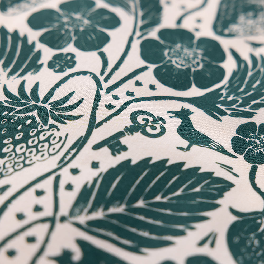 Macro detail of the white bandana's floral and crown motifs